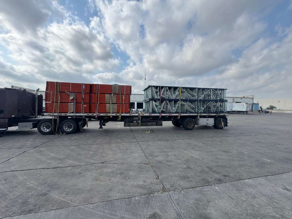 Two flatbed trailers loaded with rack components