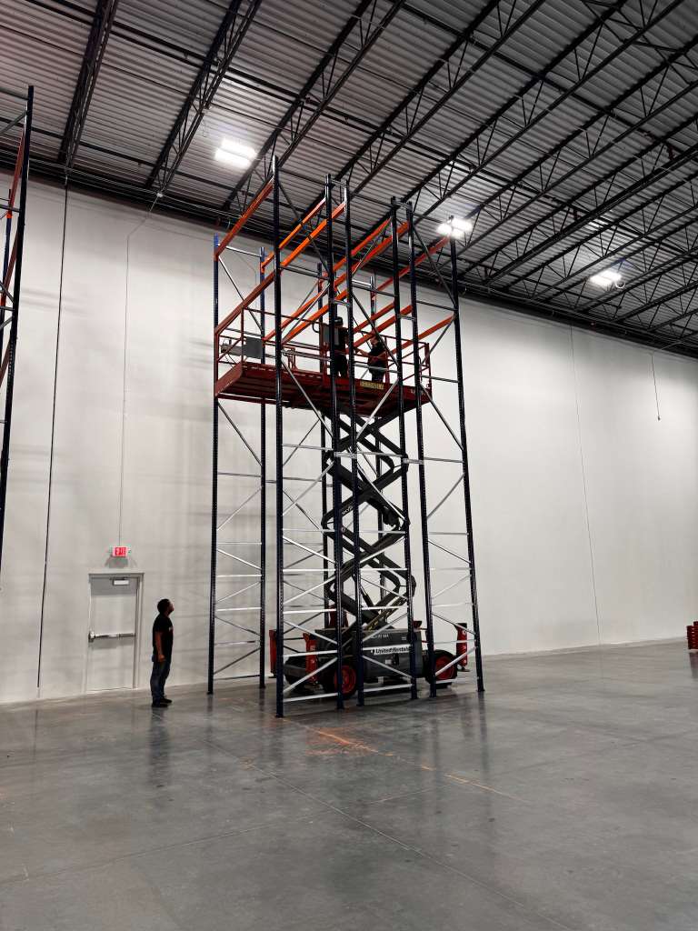 Close view of installation crew working on rack uprights